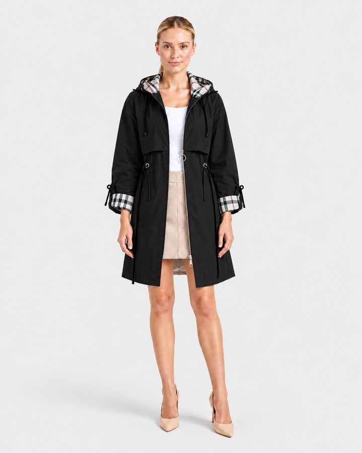 Luna Moda ROSMUNDA black lightweight windbreaker jacket with plaid hood lining and cinched waist on a model