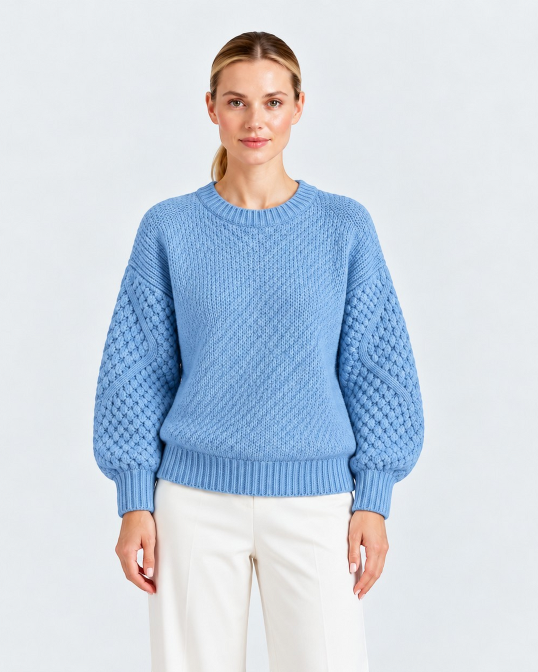 Luna Moda light blue sweater with ribbed body and textured cable knit sleeves worn by a woman on a white background.