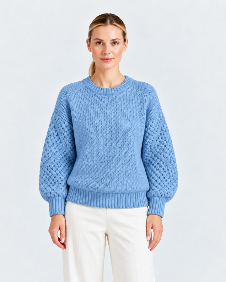 Luna Moda light blue sweater with ribbed body and textured cable knit sleeves worn by a woman on a white background.