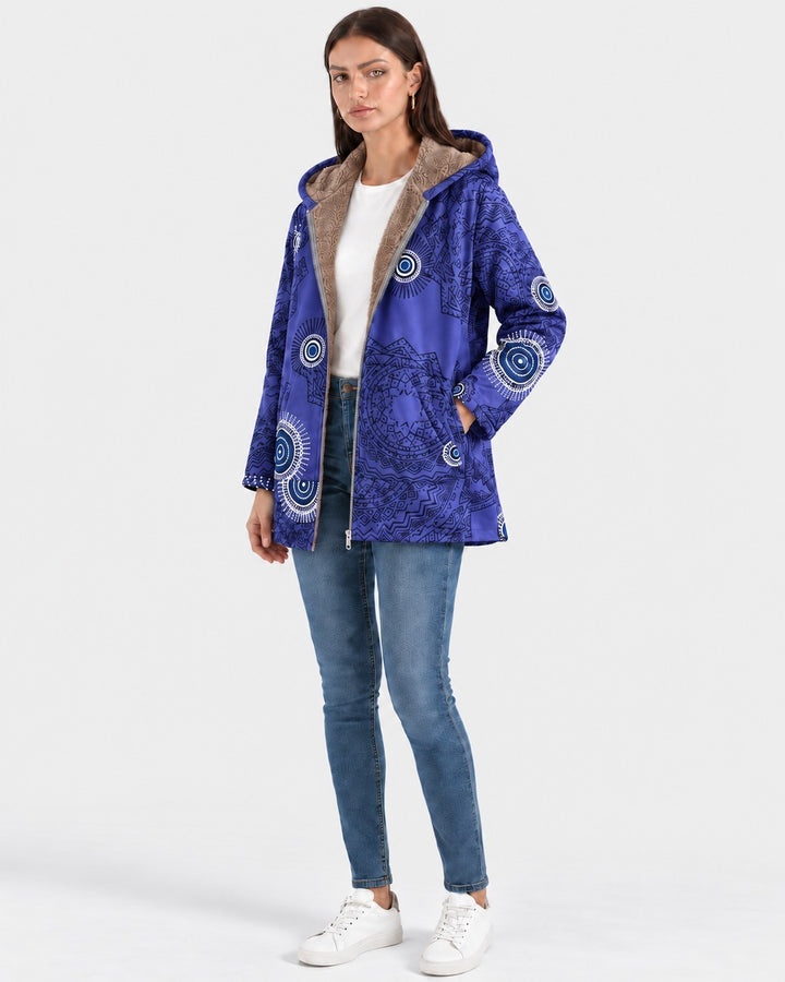 Luna Moda blue hooded jacket with geometric patterns and soft sherpa lining worn by a model with jeans and sneakers