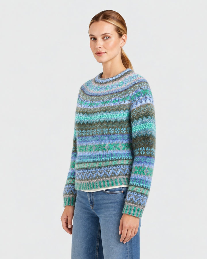 Luna Moda handmade Icelandic sweater with blue and green gradient stripes and intricate patterns on a model