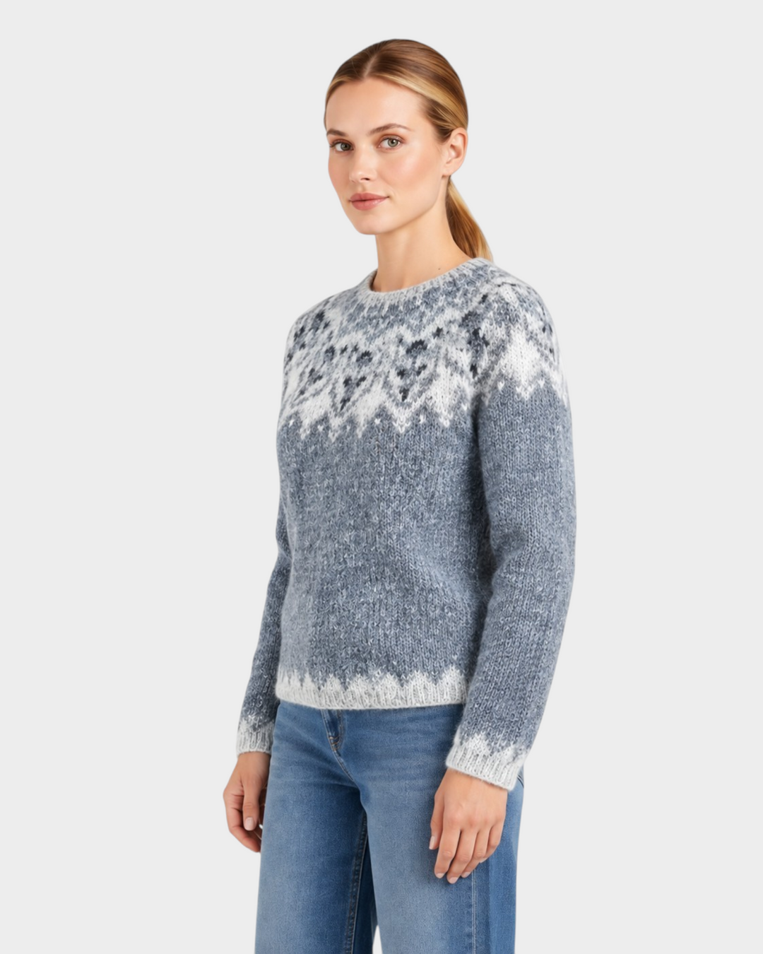 Luna Moda handmade Icelandic sweater in blue and grey with a traditional sheep pattern, worn by a woman.