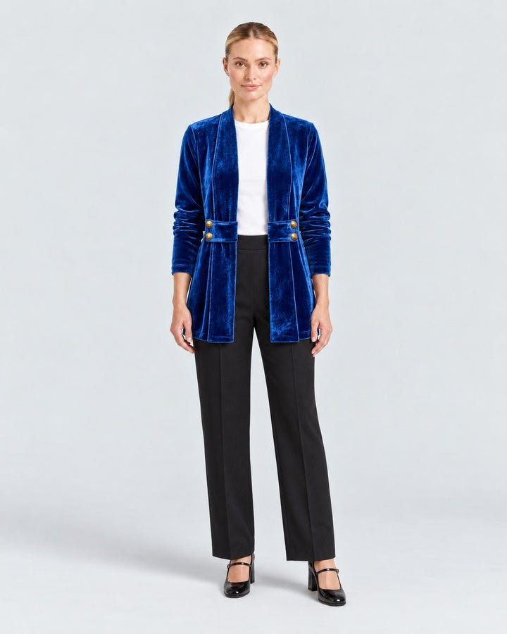 Model wearing a Luna Moda Donatella blue velvet blazer with long sleeves, open front, and gold button details.