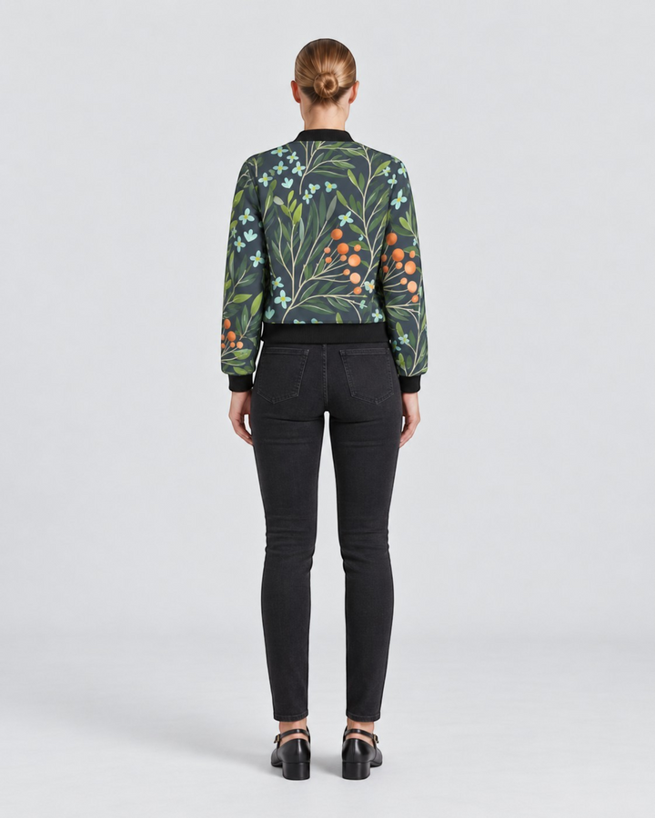 Luna Moda Sofia bomber jacket with botanical print, dark green background, orange berries, and black ribbed trim.