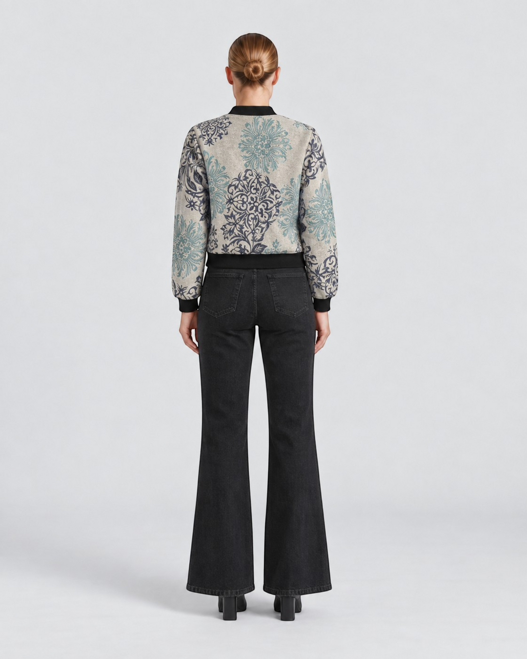 Luna Moda Sofia botanical print bomber jacket worn with black flared jeans, back view