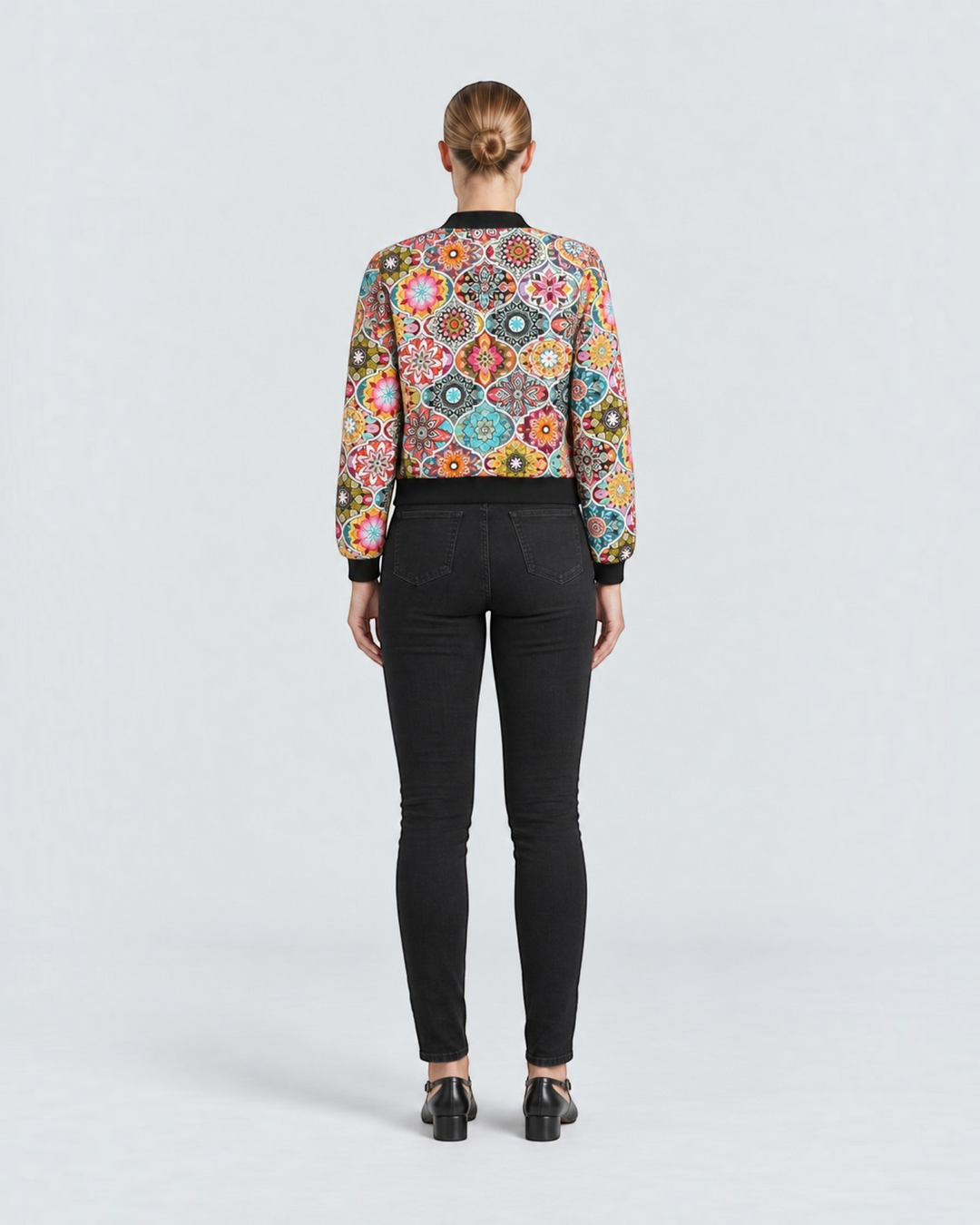 Luna Moda Sofia botanical print bomber jacket worn with black skinny jeans, back view