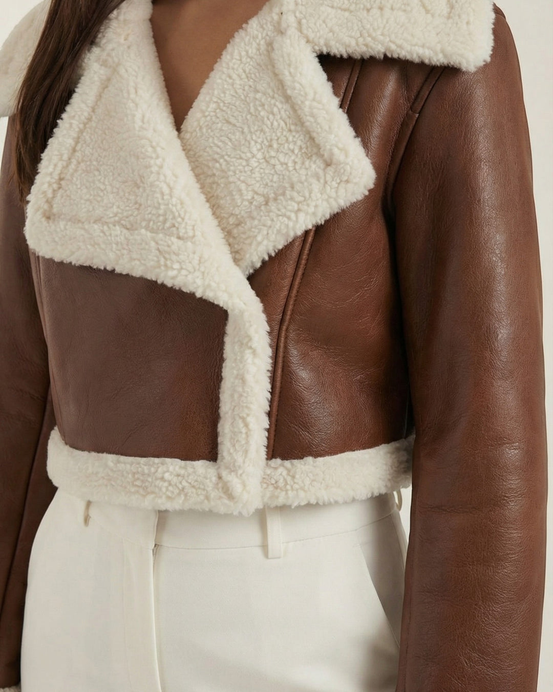 Luna Moda cropped brown faux leather jacket with cream sherpa lining and wide lapels worn by a model