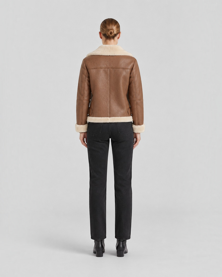Luna Moda brown faux leather jacket with fleece lining and waist belt, back view on a model with black jeans.