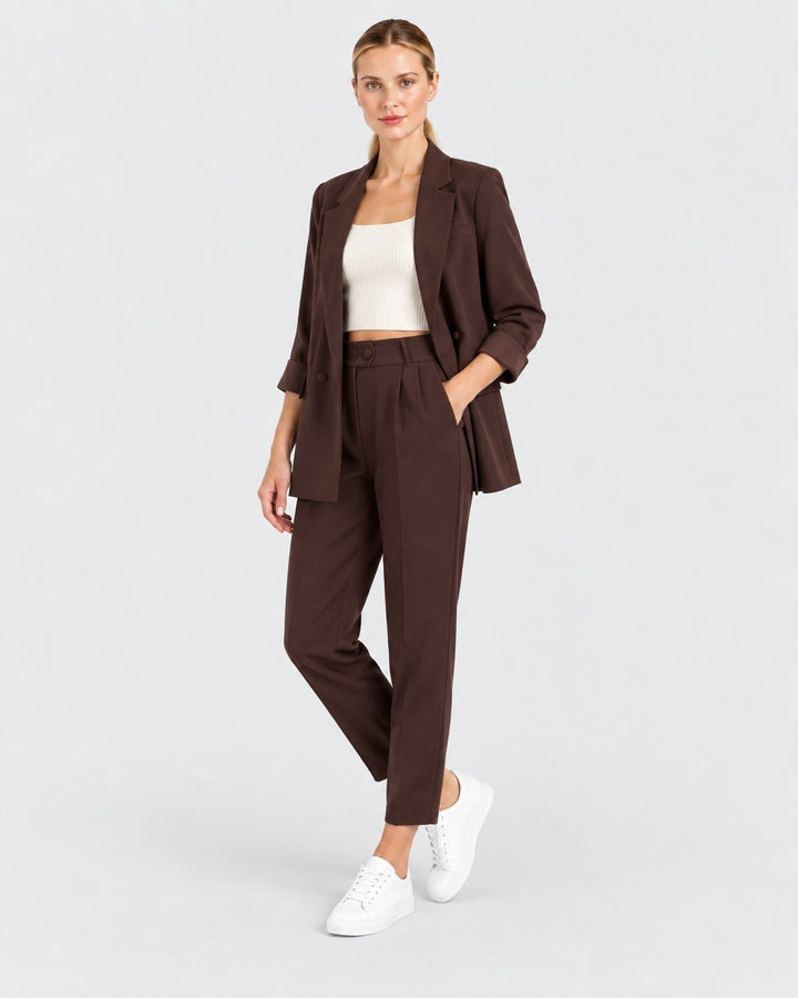 Luna Moda brown oversized blazer and fluid trousers set worn by a model with a white crop top and sneakers.