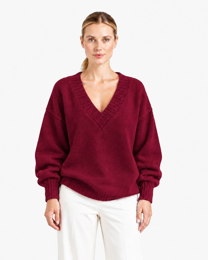 Luna Moda Nadia relaxed fit burgundy cashmere blend sweater with a deep V-neck and long sleeves on a model
