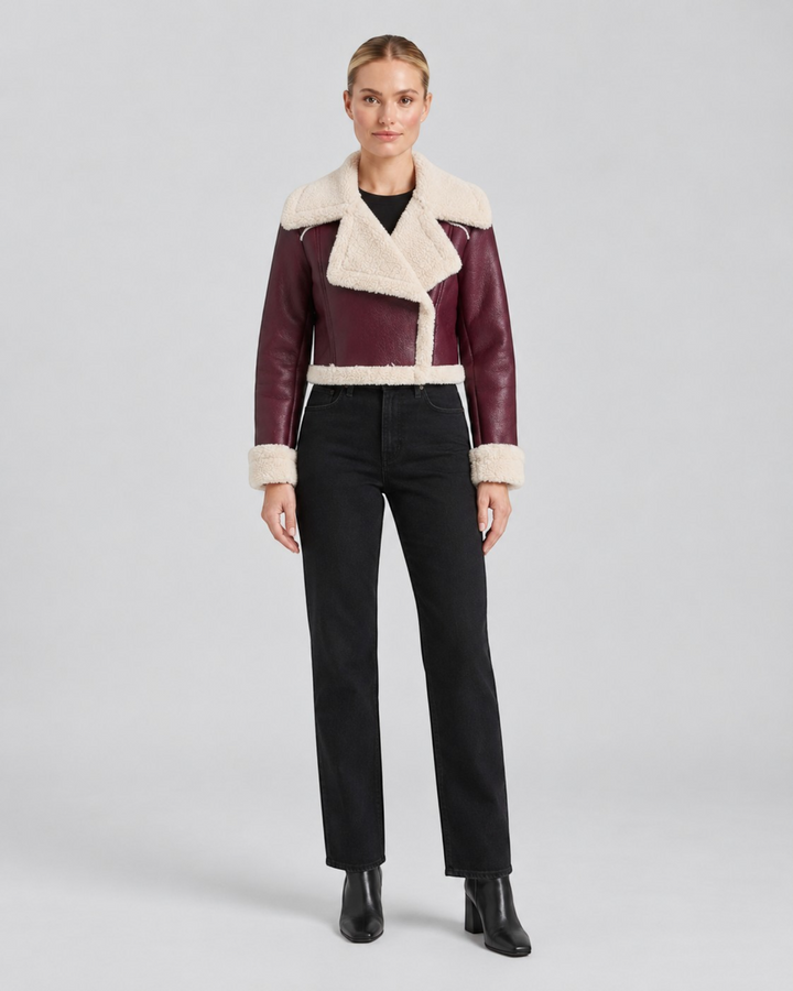 Luna Moda cropped burgundy faux leather jacket with cream fleece lining and wide collar worn by a model