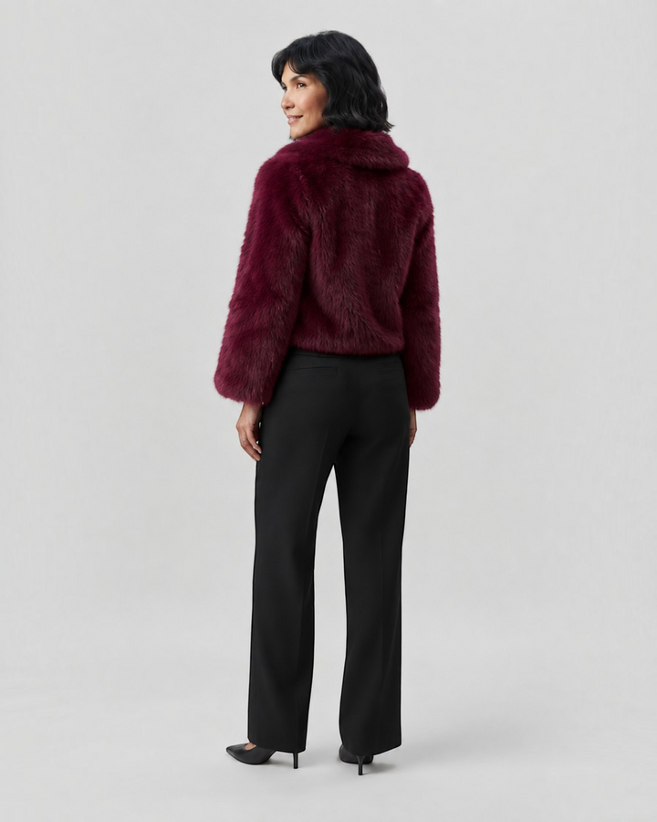 Luna Moda Margherita burgundy faux fur coat with wide collar worn by a woman from the back view