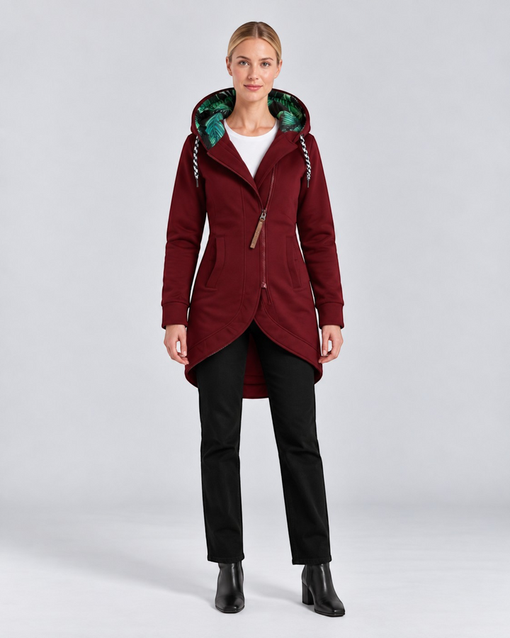 Luna Moda burgundy hooded coat with asymmetrical zip, green leaf print lining, and high-low hem on a female model