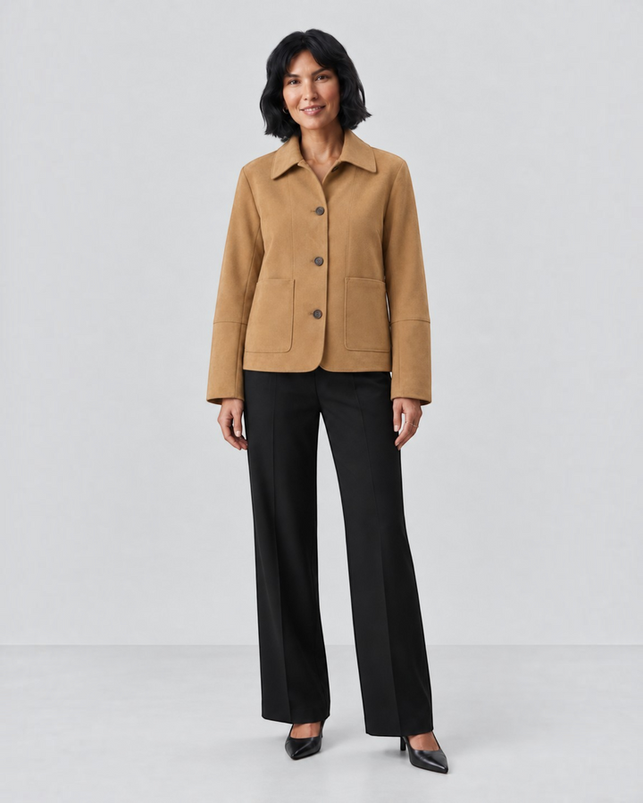 Model wearing a Luna Moda camel cropped button-up jacket with patch pockets, styled with black trousers and heels.
