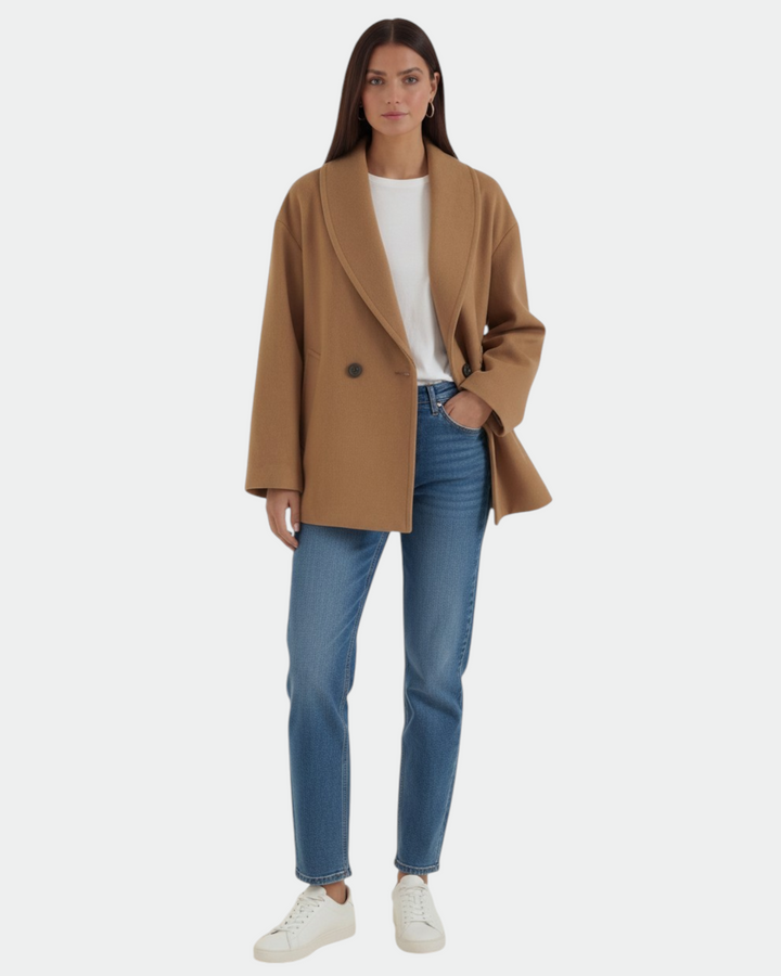 Model wearing a Luna Moda camel oversized double-breasted coat with wide lapels over a white top and blue jeans