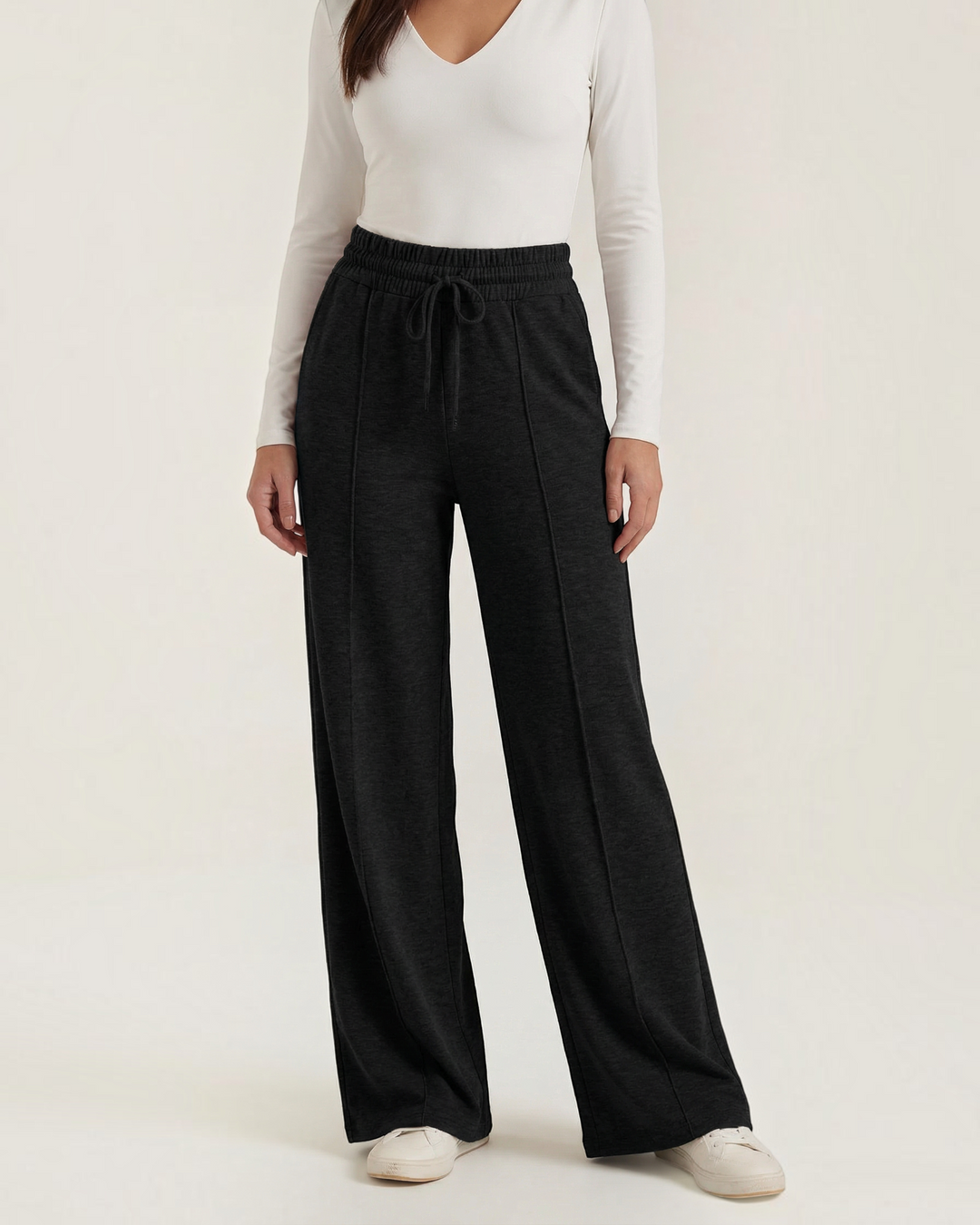 Luna Moda high-waisted black palazzo pants with drawstring waist, wide legs, and front seam detailing on a model.