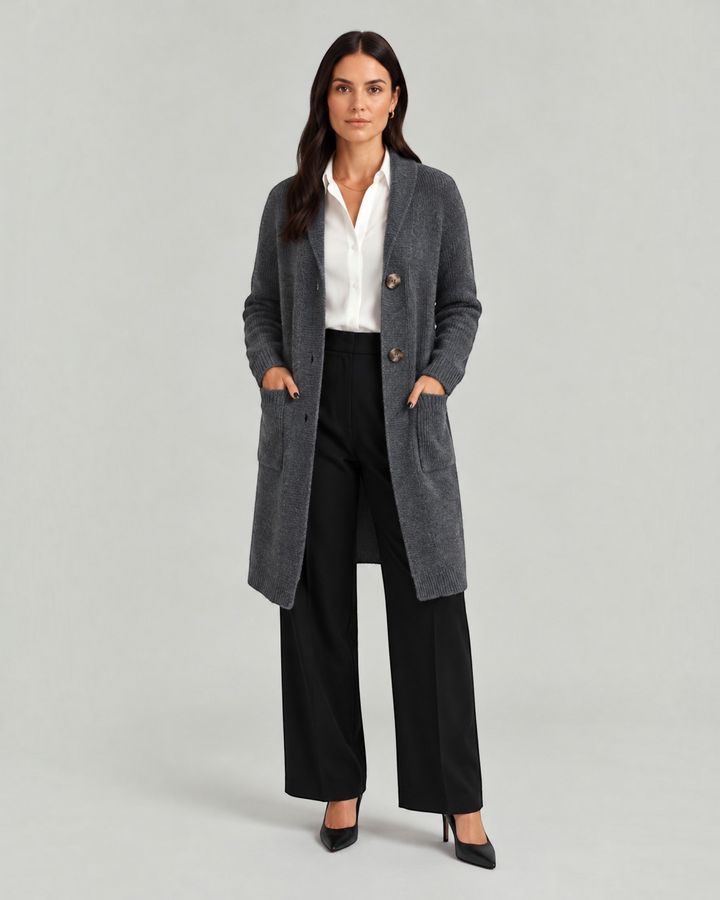 Luna Moda Chiara long charcoal grey knit cardigan with front pockets worn by a woman over a white shirt and trousers