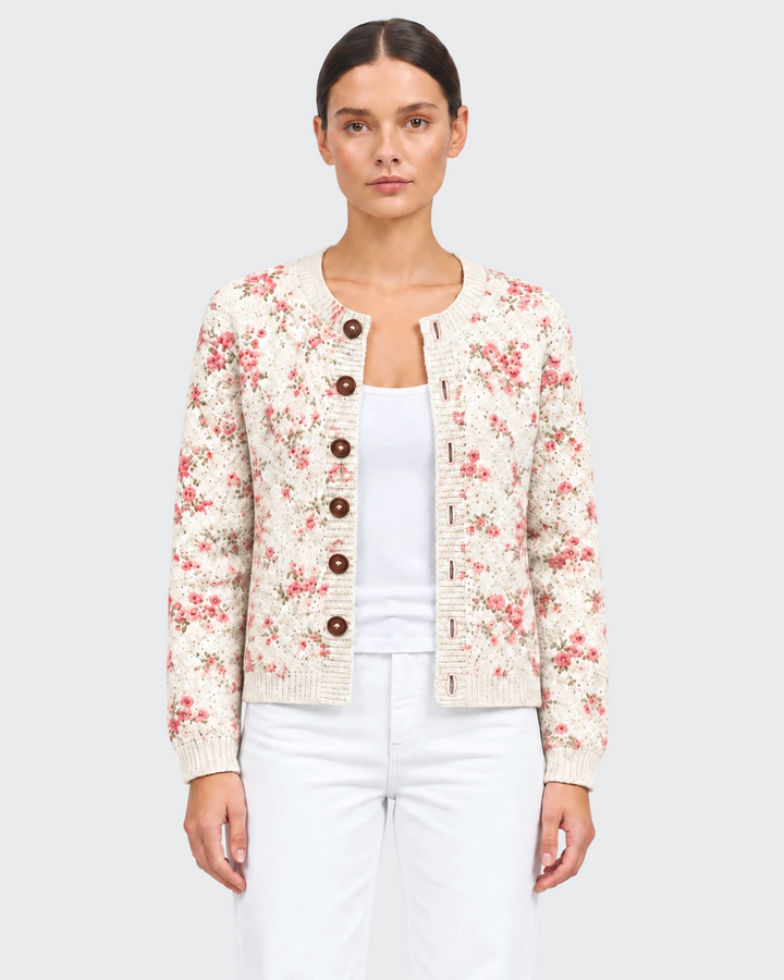 Luna Moda Claudia cream cardigan with pink rose floral print, dark tortoise buttons, and ribbed trim on a model