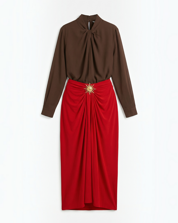 Luna Moda midi skirt in red with front draping and a gold sun-shaped brooch, paired with a brown long-sleeve blouse.