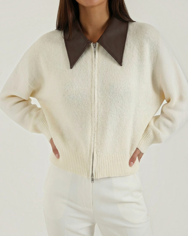Luna Moda cropped cream knit cardigan with a brown contrast collar and double zip front closure.