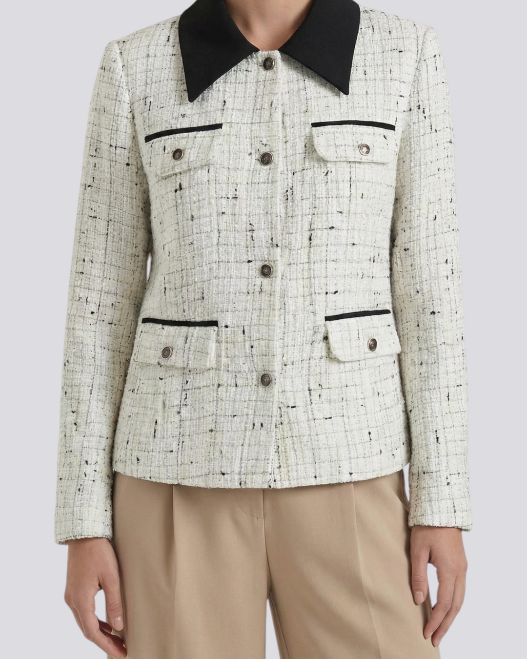 Luna Moda Ida tweed jacket in white with black contrast collar and button-down front, worn with beige trousers.