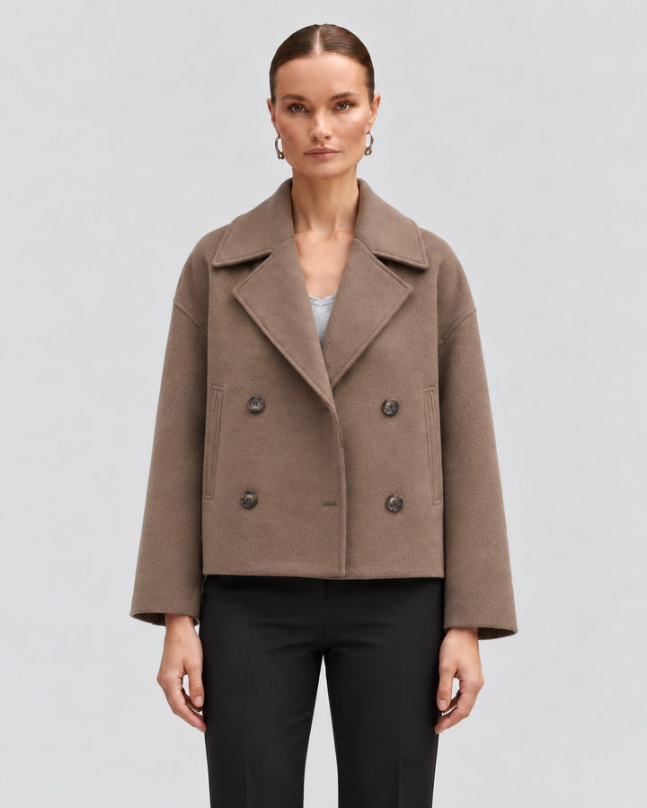 Luna Moda Costanza brown double-breasted short jacket with wide lapels worn by a model on a light grey background.