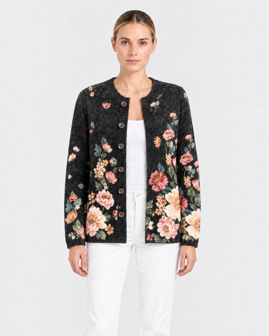 Luna Moda Costanza vintage-style black knit cardigan with pink and sage green floral pattern and dark front buttons.