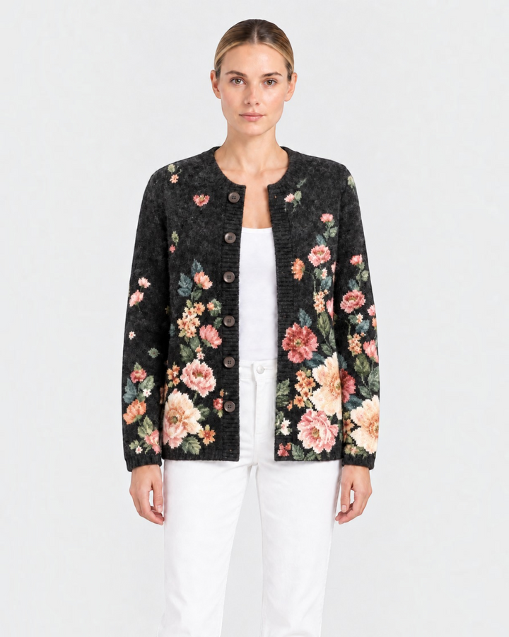 Luna Moda Costanza vintage-style black knit cardigan with pink and sage green floral pattern and dark front buttons.