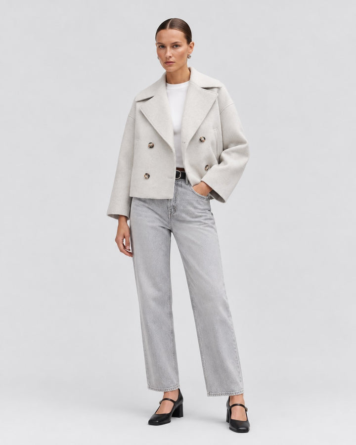 Luna Moda Costanza short double-breasted jacket in light grey wool worn by a model with grey jeans and black heels.