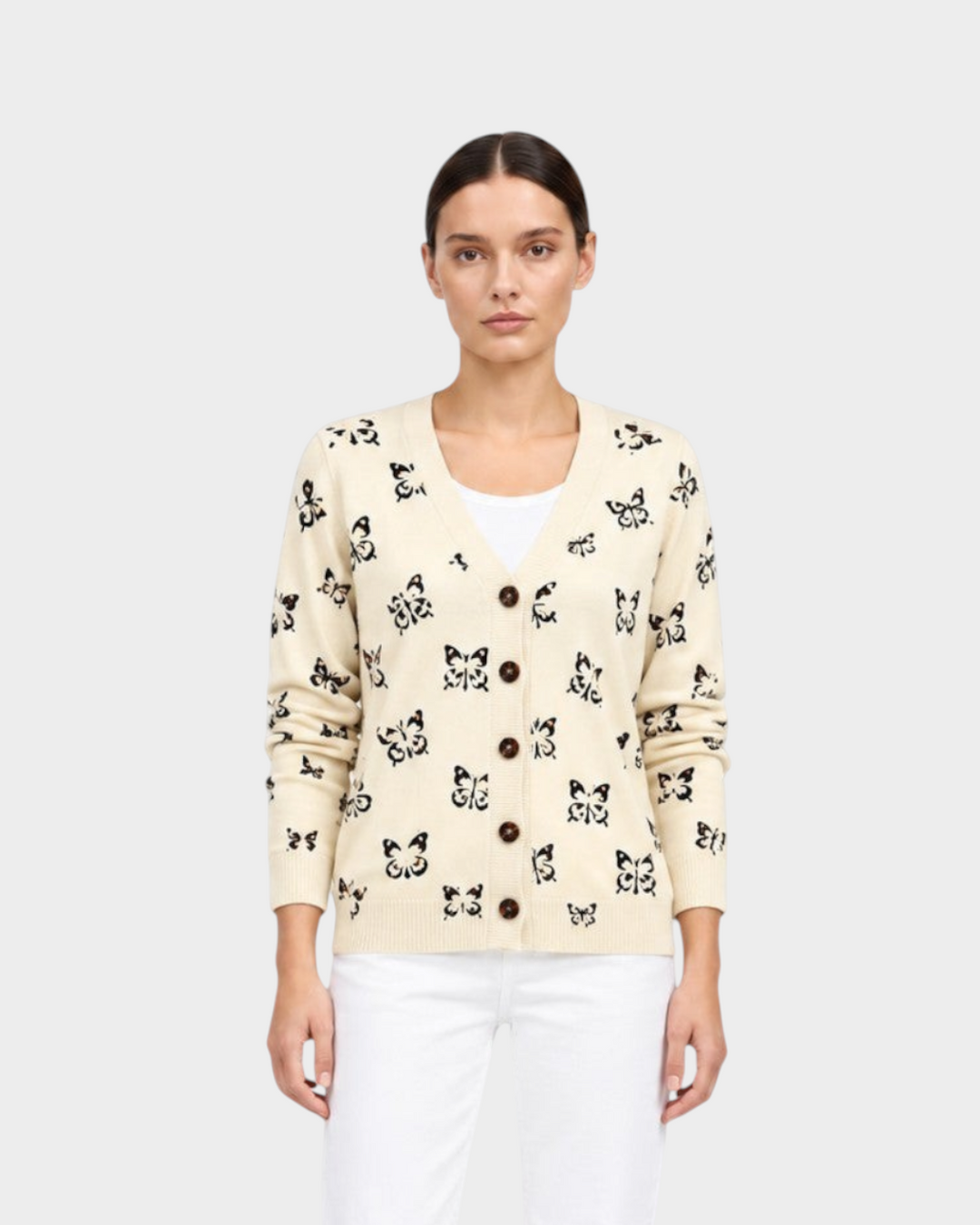 Luna Moda Teresa cardigan in cream with black butterfly print, featuring a V-neck and button-down front closure.