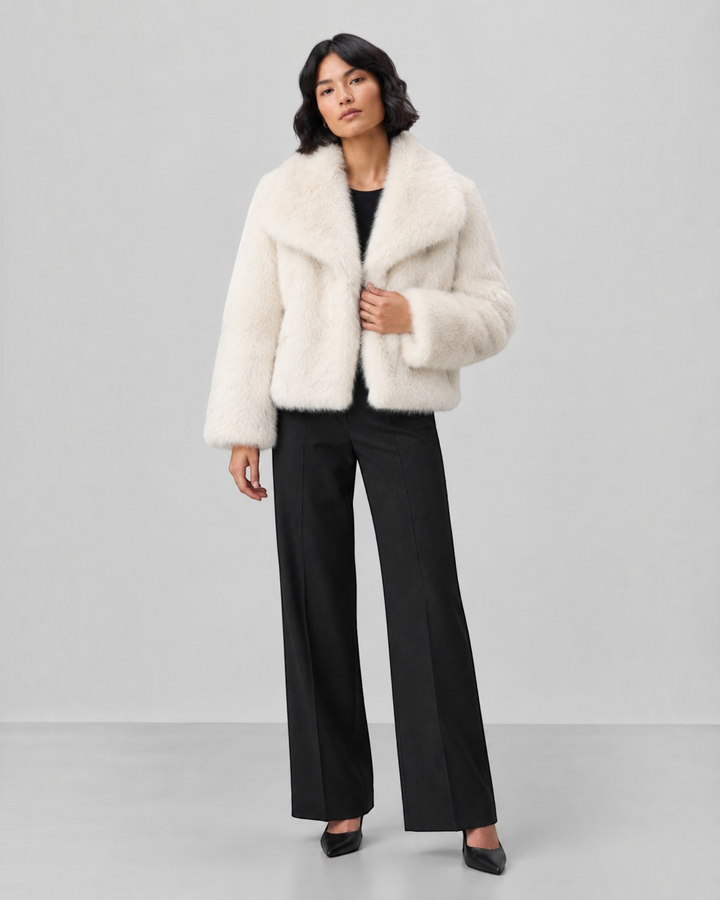 Luna Moda cream faux fur coat with a wide collar worn by a model with black trousers and heels