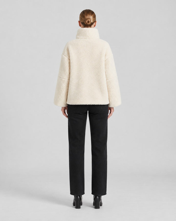 Luna Moda Anastasia cream fleece coat with a high collar and loose fit, shown from the back on a model.