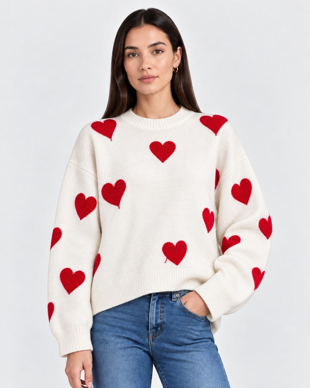 Luna Moda oversized cream knit sweater featuring a playful red heart pattern worn by a model with blue jeans