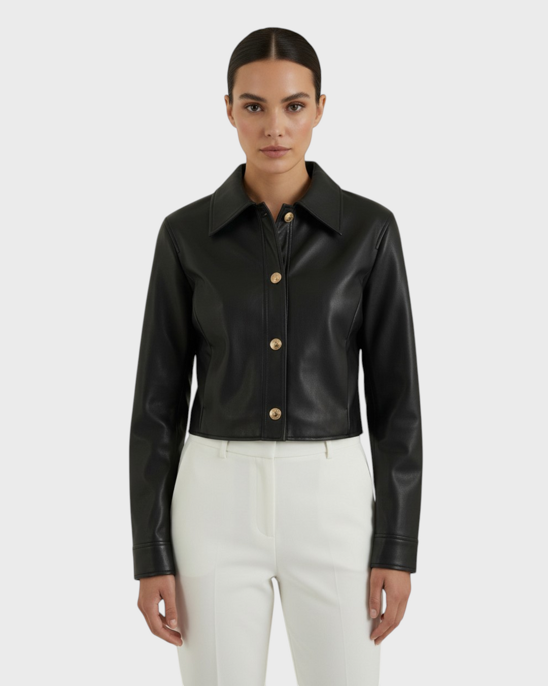 Luna Moda Elettra black faux leather cropped jacket with gold snap buttons worn by a model