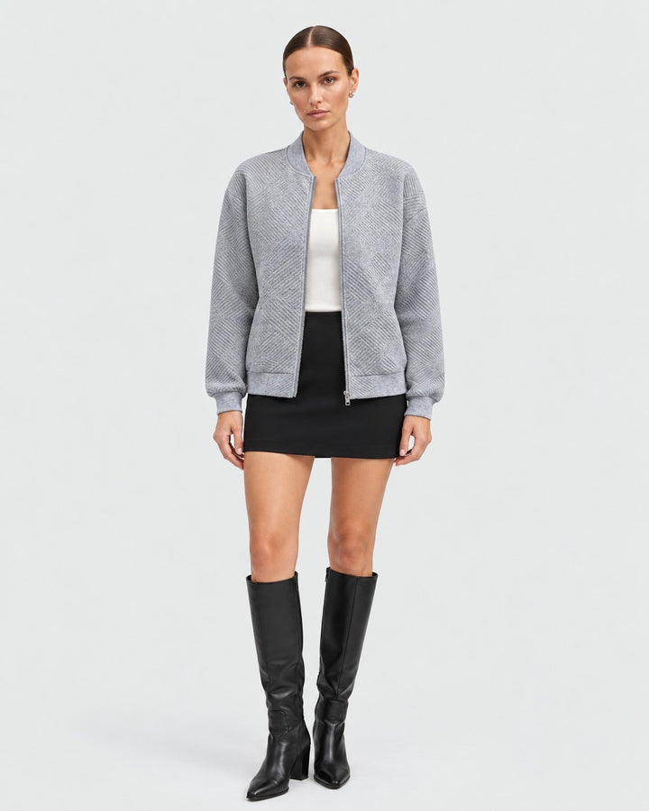 Luna Moda Dora grey bomber jacket with geometric pattern, featuring a front zip and ribbed cuffs on a female model.