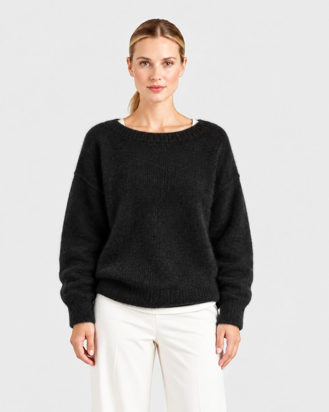 Luna Moda Elda black crew neck sweater with a soft, relaxed fit worn by a model against a neutral background.