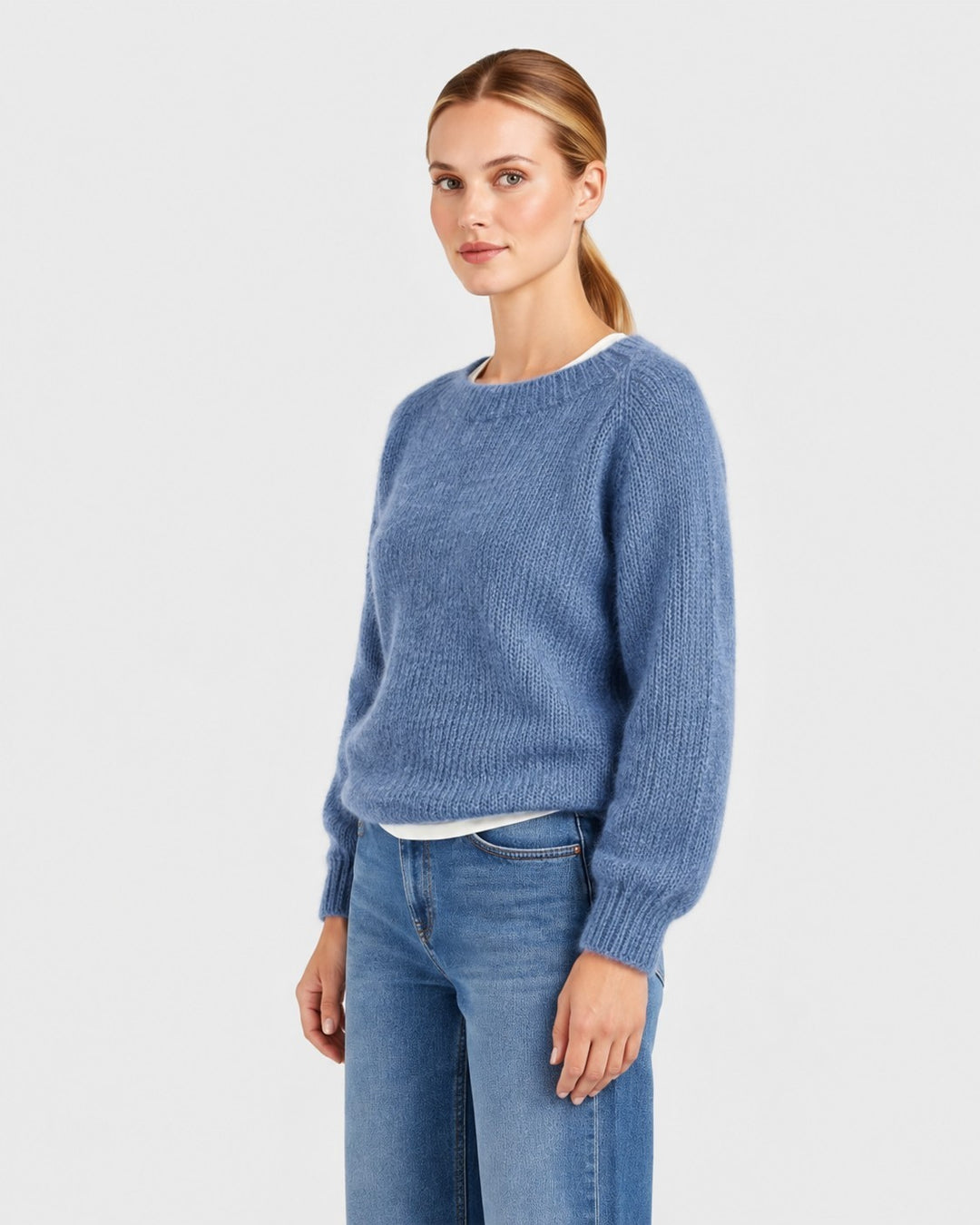 Luna Moda Elda blue crew neck sweater with a soft, relaxed fit worn by a model with jeans.
