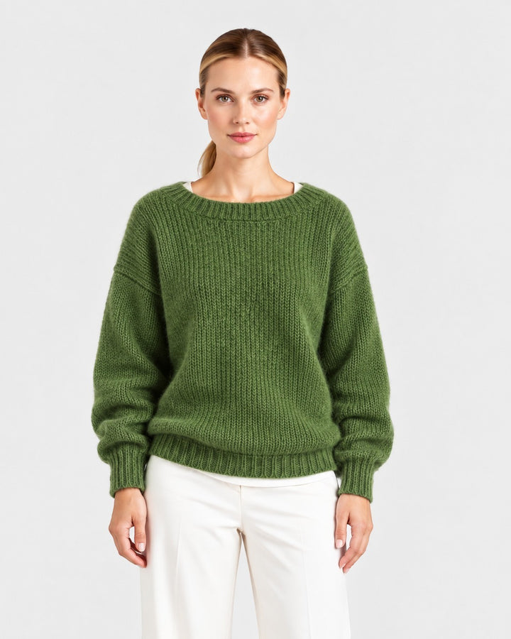 Luna Moda Elda green crew neck sweater with a soft, relaxed fit worn by a model with white trousers.