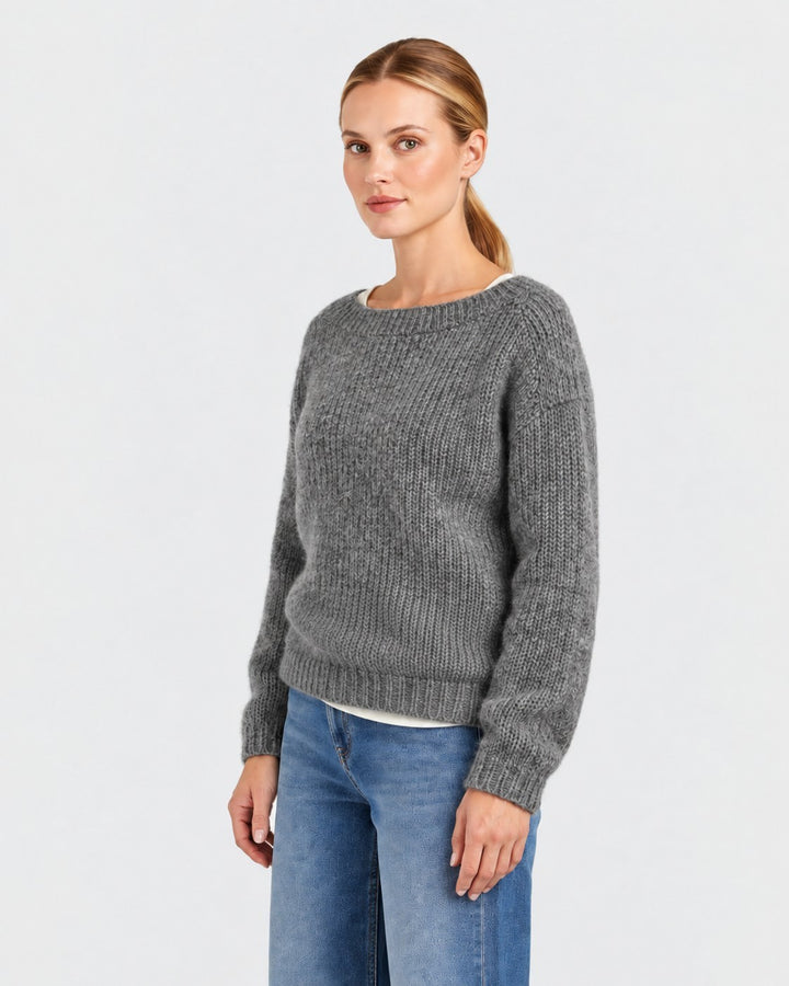 Luna Moda Elda grey crew neck sweater with a soft, chunky knit texture worn by a woman with blue jeans.