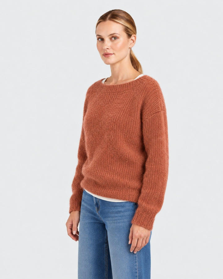 Luna Moda Elda crew neck sweater in a soft, fuzzy terracotta knit worn by a woman with blue jeans.