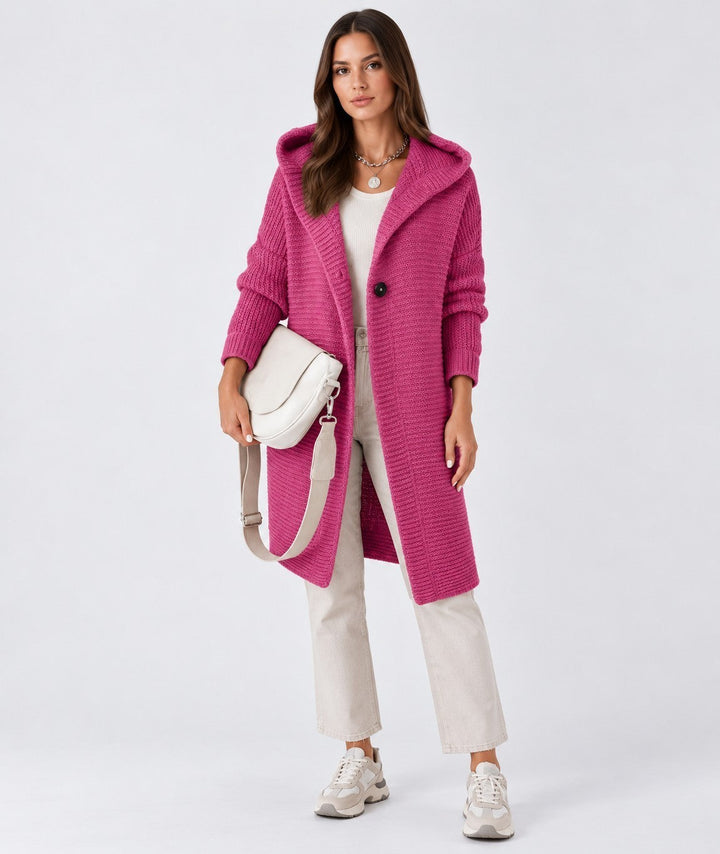 Luna Moda Elena long fuchsia knitted cardigan with hood and button closure worn by a model with beige trousers
