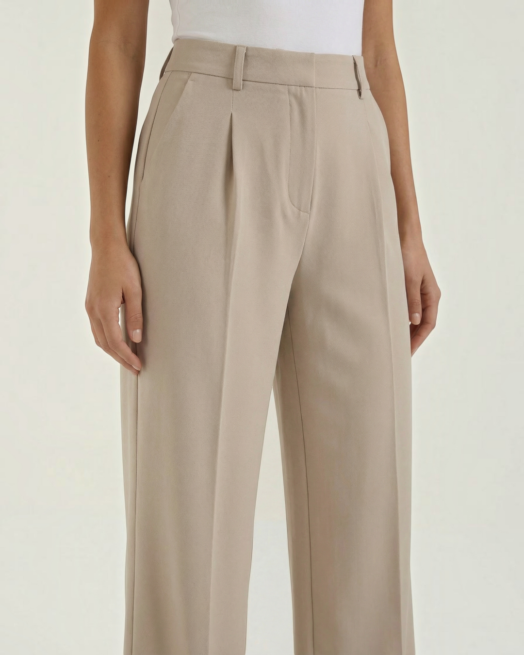 Luna Moda high-waisted beige palazzo trousers with pleated front detail and belt loops on a model