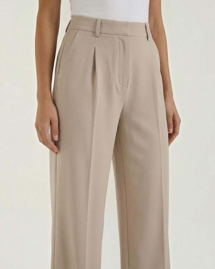 Luna Moda high-waisted beige palazzo trousers with pleated front detail and belt loops on a model