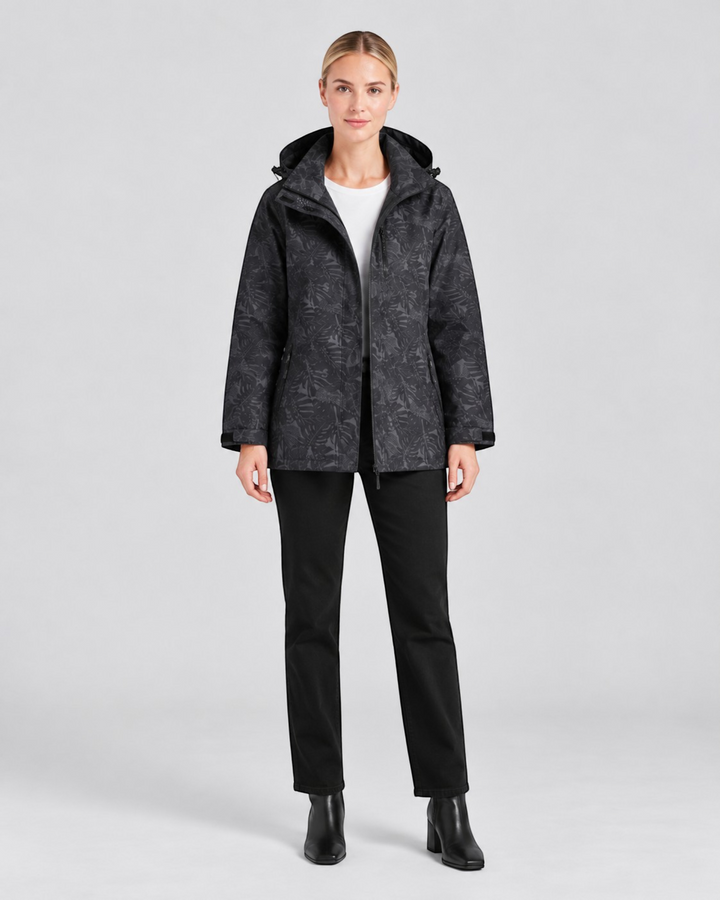 Luna Moda Eufemia lightweight waterproof hooded jacket in black with a subtle leaf pattern worn by a female model