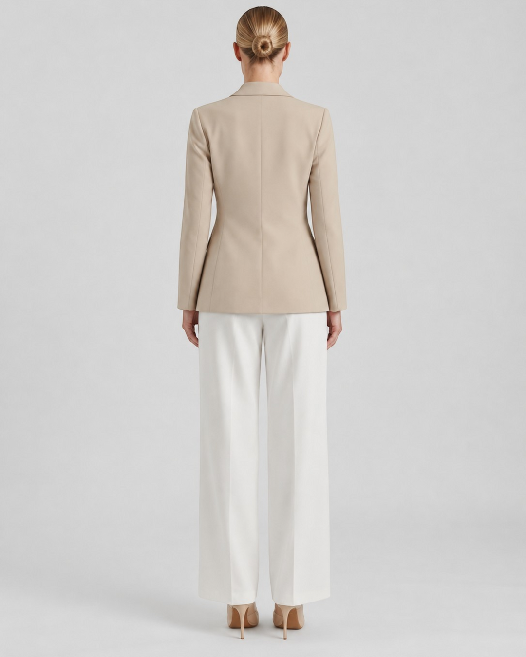 Luna Moda Felicia long beige blazer with tailored waist and padded shoulders, back view on a model