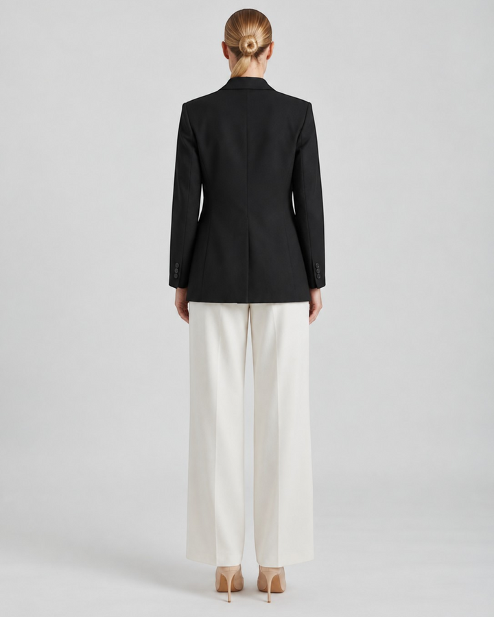 Luna Moda Felicia long black tailored blazer with padded shoulders and defined waist, back view on a model
