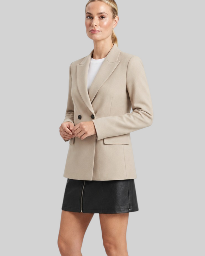 Luna Moda Felicia long beige blazer with padded shoulders and tailored waist worn with a black skirt and boots