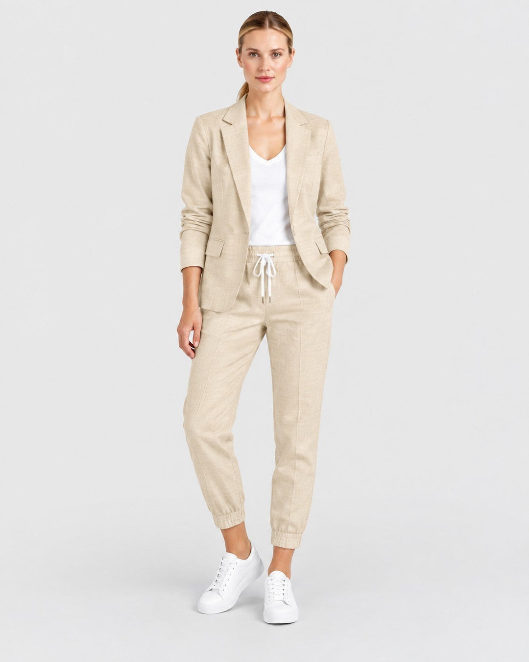Luna Moda Fiorenza beige lightweight blazer and jogger pant set worn by a woman with white sneakers