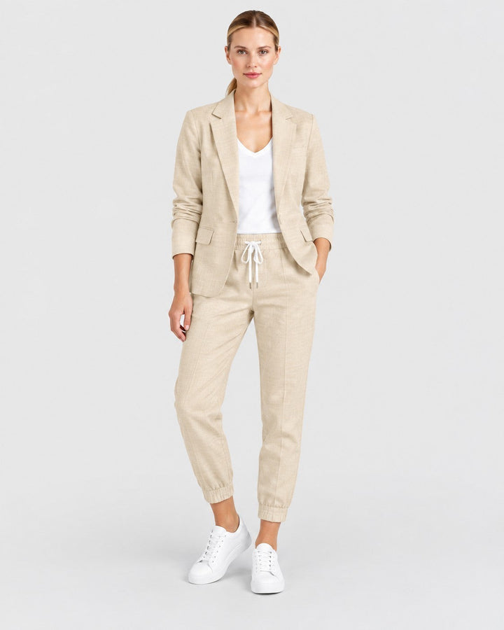 Luna Moda Fiorenza beige lightweight blazer and jogger pant set worn by a woman with white sneakers