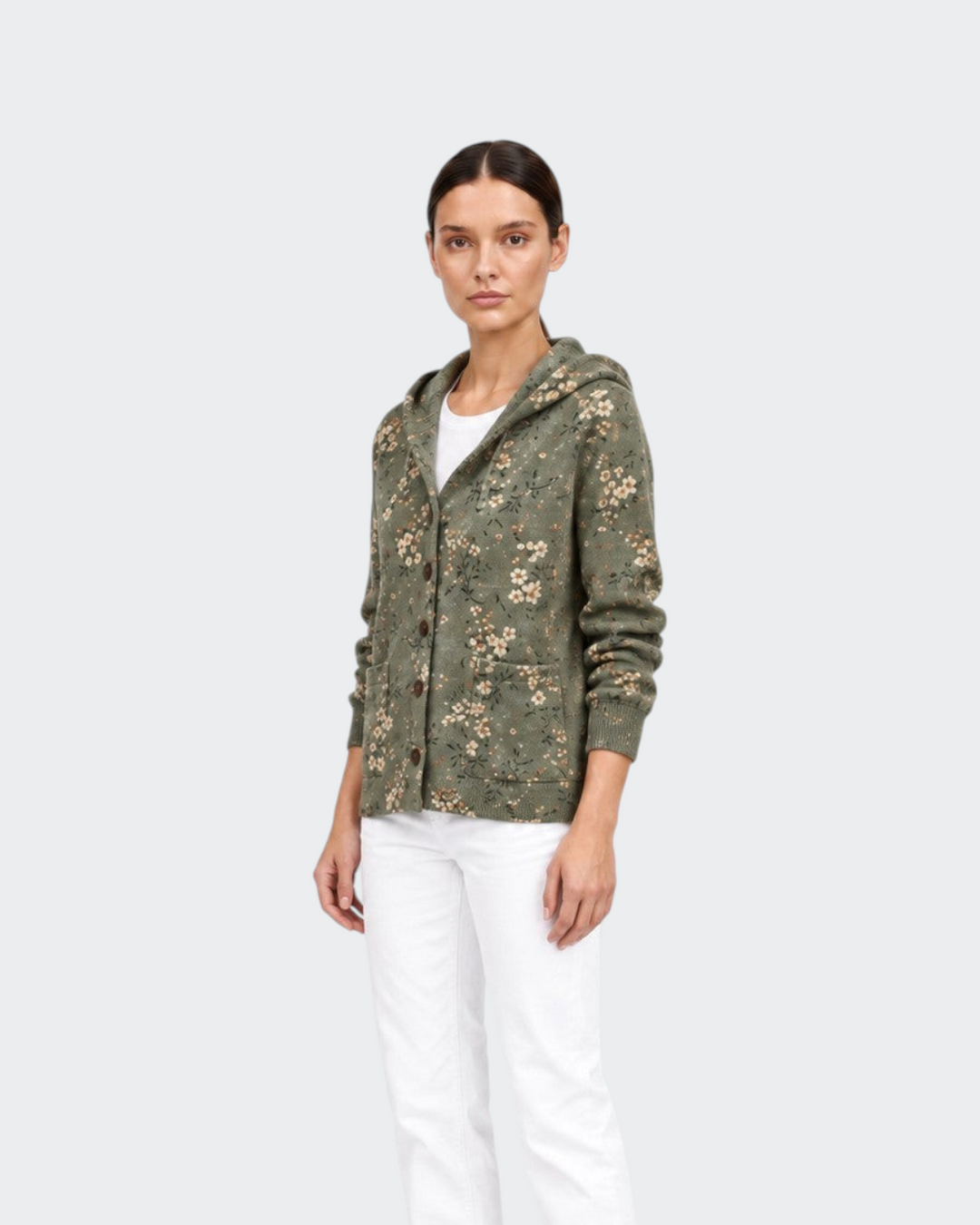 Luna Moda floral knit cardigan with hood in olive green, worn by a model with white trousers and black boots.
